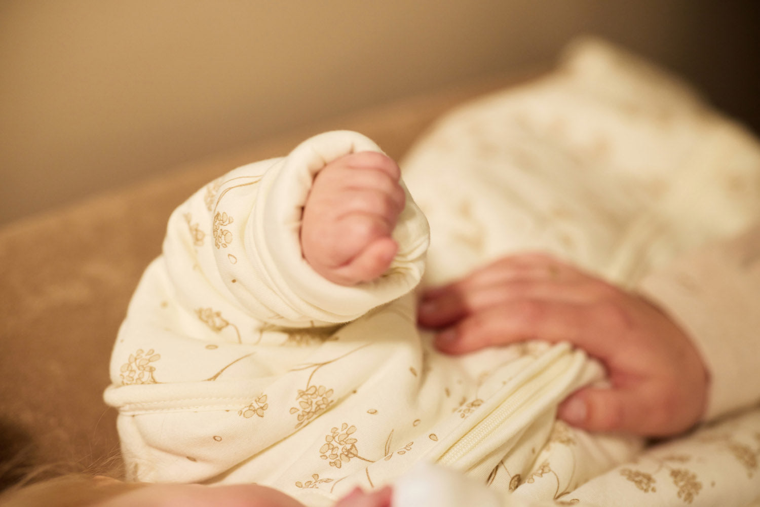 Close-up of a baby's hand who is wearing a cozy sleeping bag